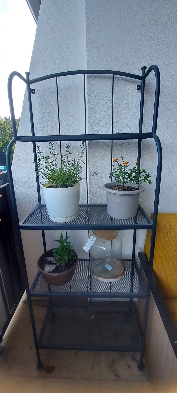 Black metal shelf on a balcony